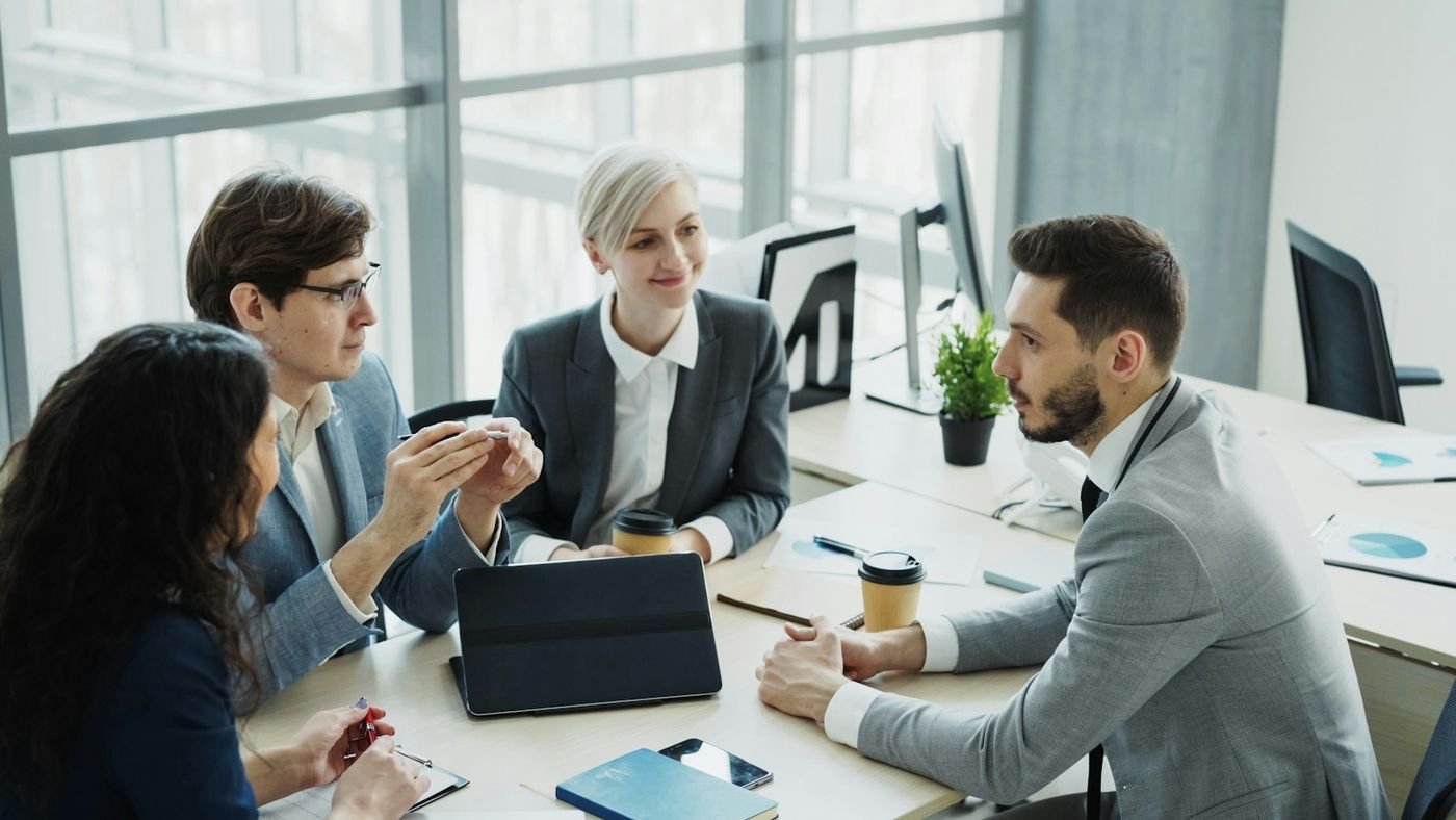 Equipo de trabajo reunido alrededor de una mesa en una oficina